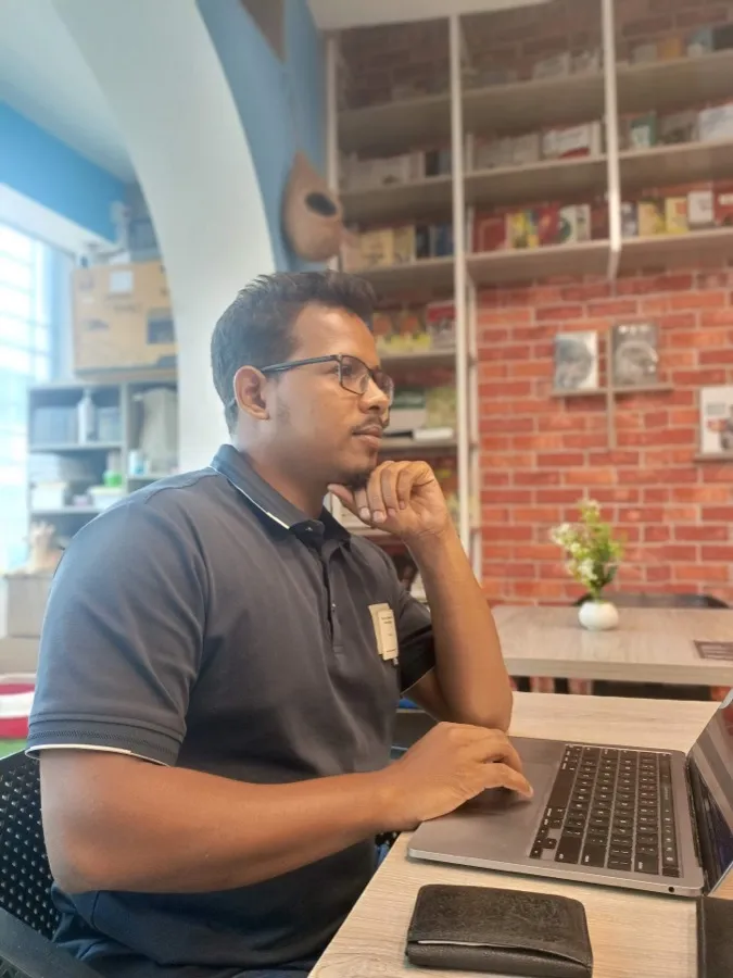 Zakir Hossen, founder of JuggleHire, working on his laptop