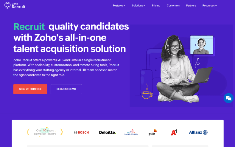 A girl with laptop smiling in the homepage of Zoho Recruit to discuss Recruitee alternatives